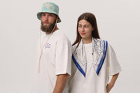 Two models in Crimea Beach Party tees, one with the blue-trimmed Cria Beach Club scarf