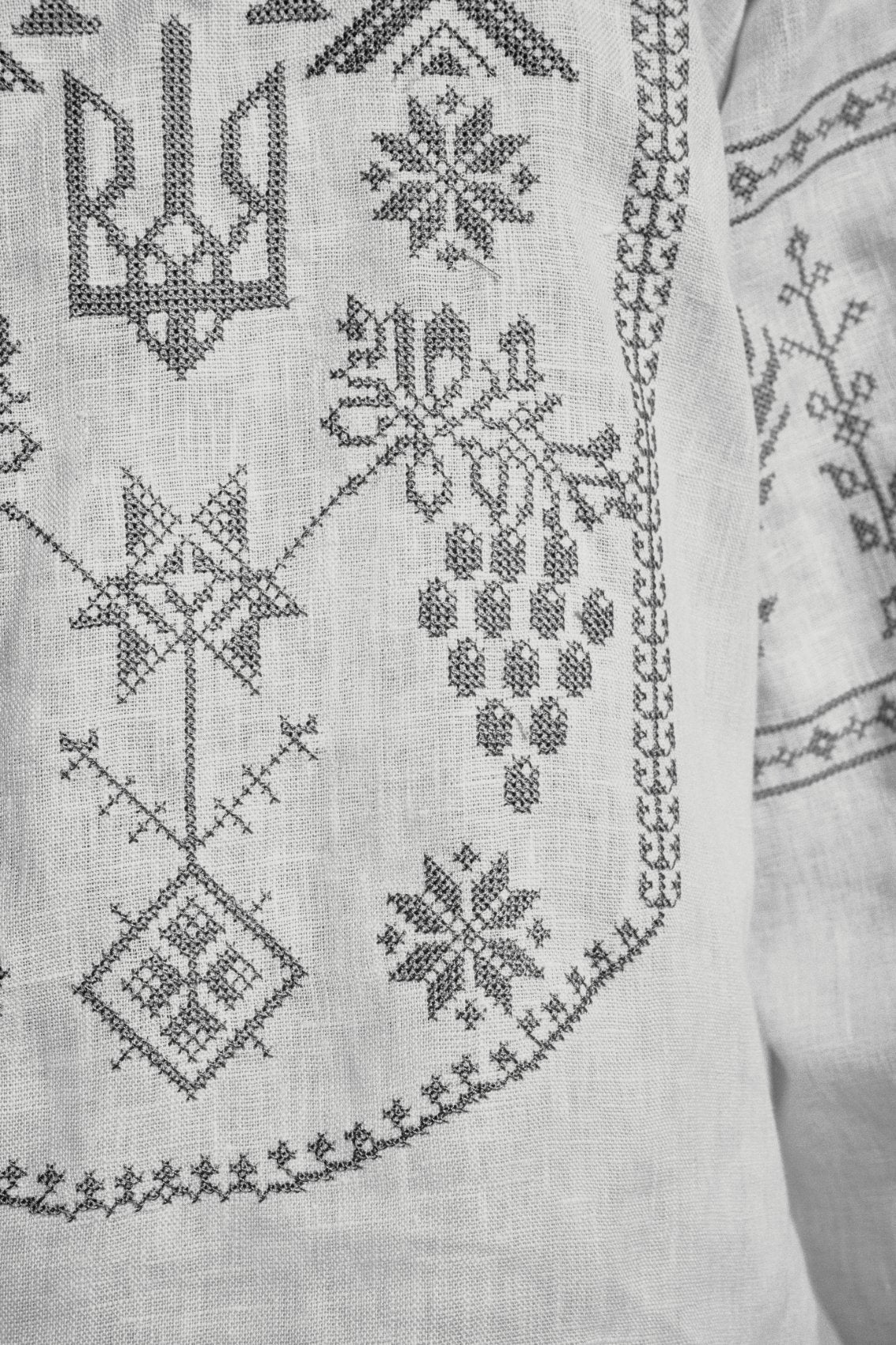 The grapevine she chose, cross-stitched in the front panel of the vyshyvanka