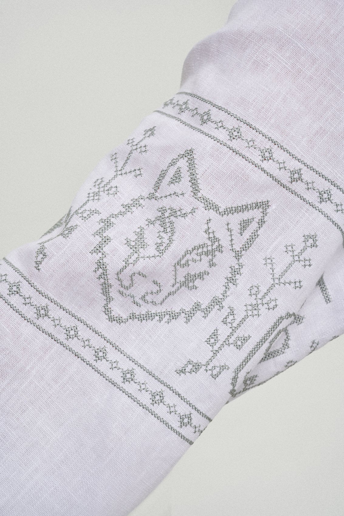 The wolf she chose, cross-stitched on the sleeve of the vyshyvanka